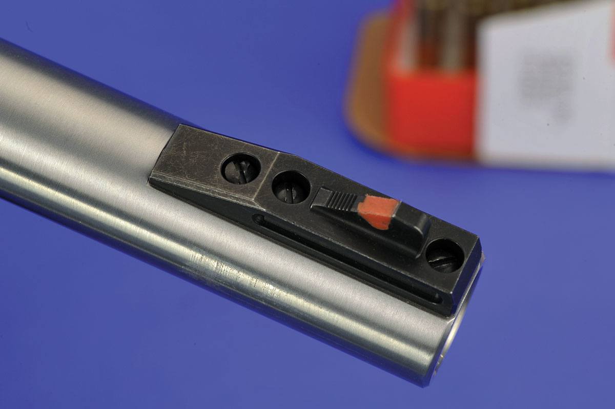 In concert with the adjustable rear sight, the front sight blade has a color easily contrasted with the white outline rear notch. This assembly is fully removable to make smooth barrel or for a change to aftermarket sights.